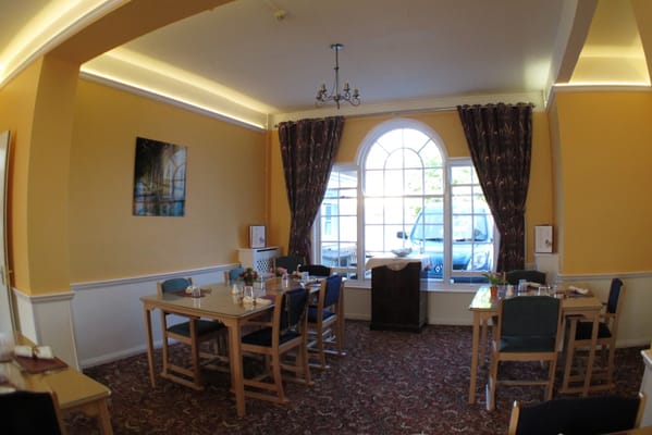 Dining area with tables set for residents