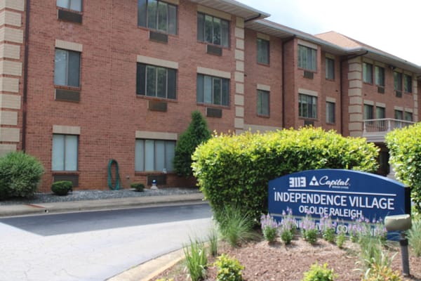 Exterior view of Independence Village of Olde Raleigh with sign