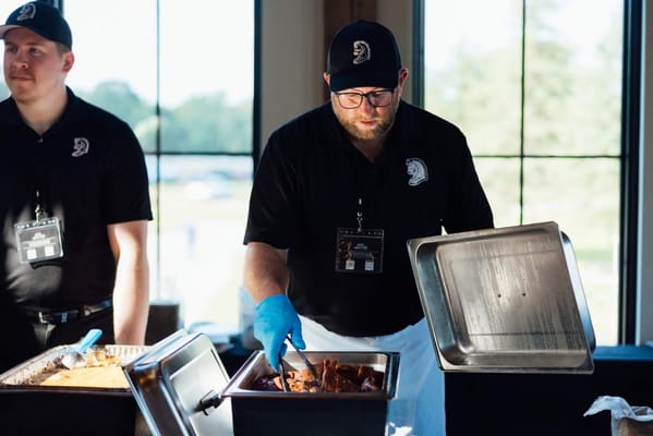 Staff serving food at a meal service event