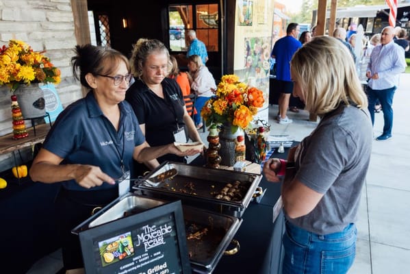 Staff serving food at an outdoor event