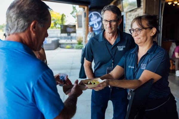 Staff serving food to residents in a community setting
