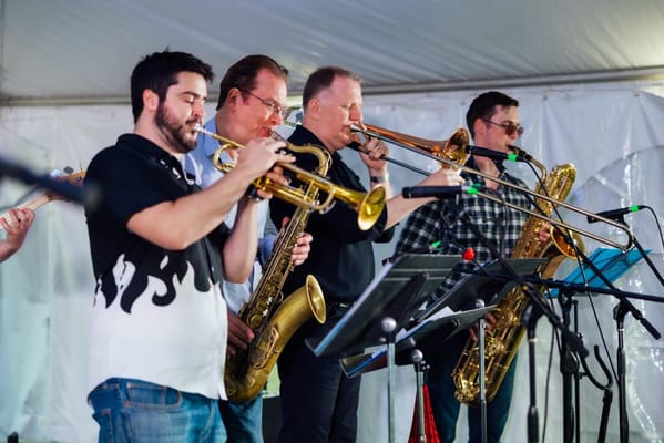 Musicians performing with brass instruments at an event