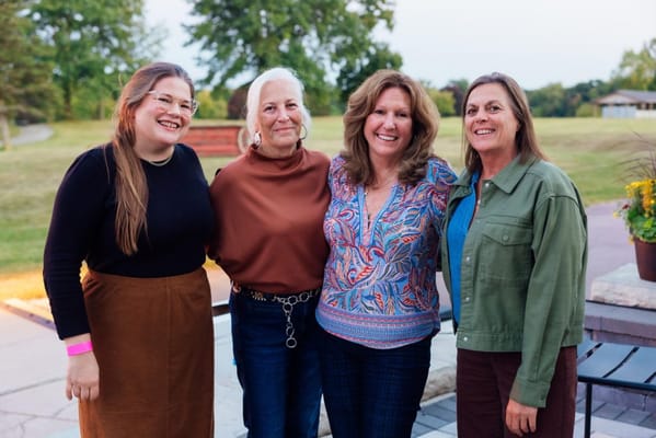 Group of women posing outdoors in a social setting