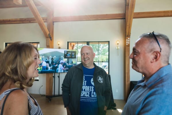 Residents and staff engaging in conversation in the facility