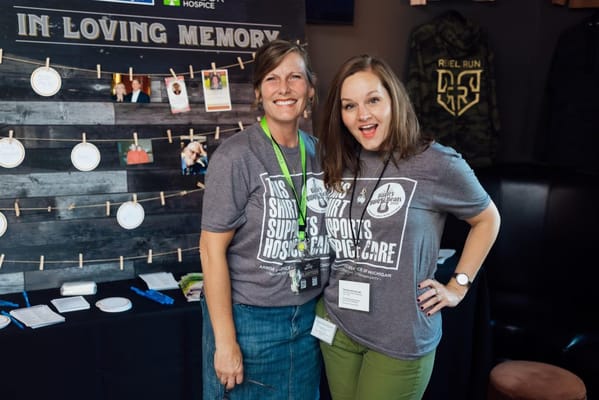 Two staff members smiling at an event