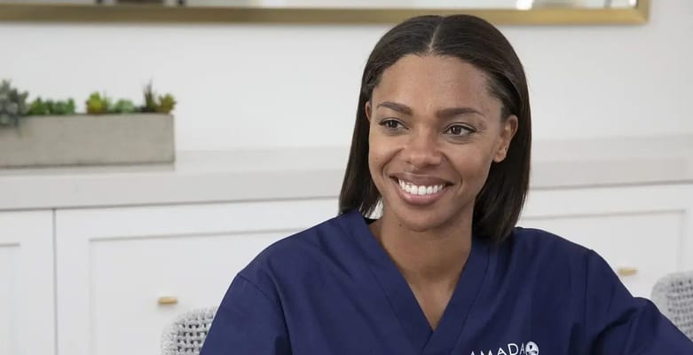 A staff member smiling in a care environment