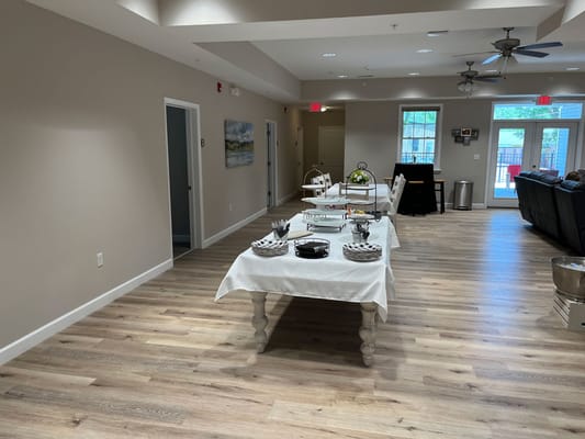 Interior common area with tables and chairs arranged.