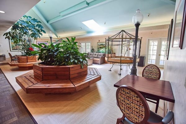 Bright and welcoming interior common area with plants and seating