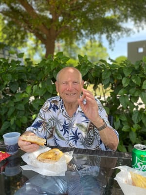 Resident enjoying a meal outdoors in a garden area