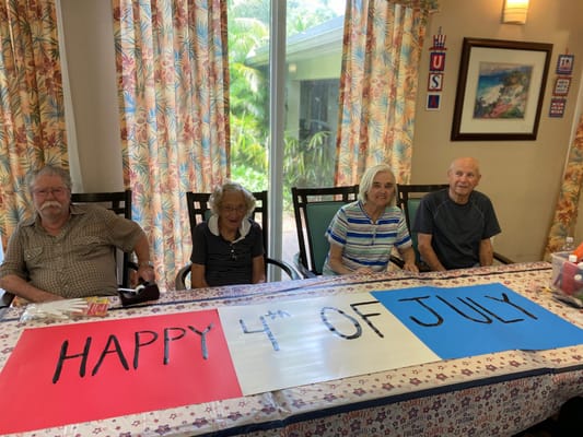 Residents celebrating with a Fourth of July banner