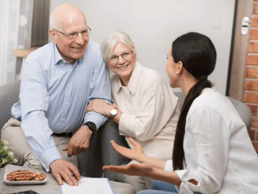 Residents socializing with staff in a cozy sitting area