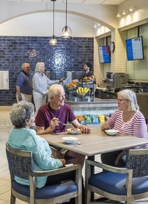 Residents enjoying snacks in the dining room
