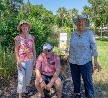 Three residents enjoying time outdoors in a garden
