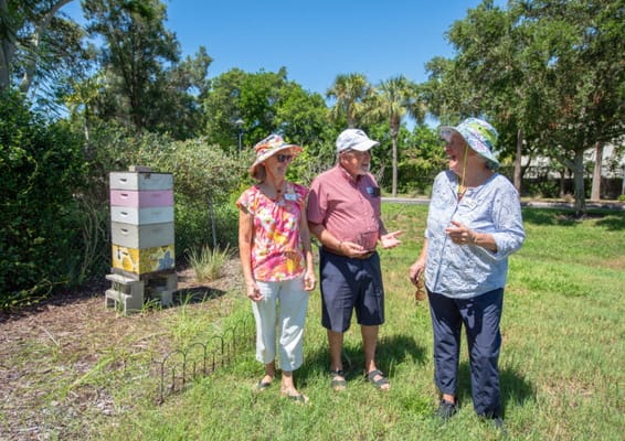 Three residents conversing in a garden area