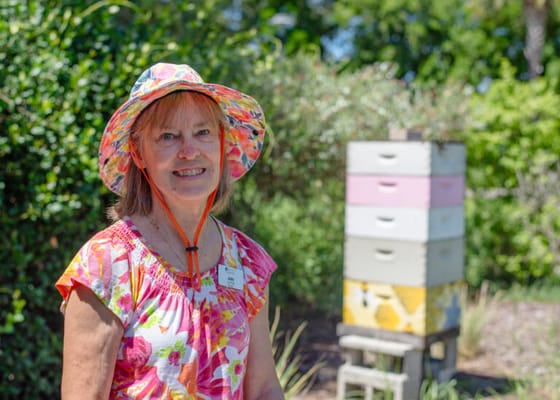 A smiling resident in a garden setting
