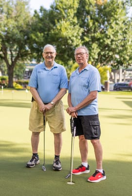 Two residents enjoying golf on an outdoor green