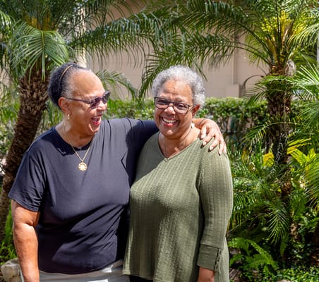 Two residents enjoying a moment outdoors in a lush garden