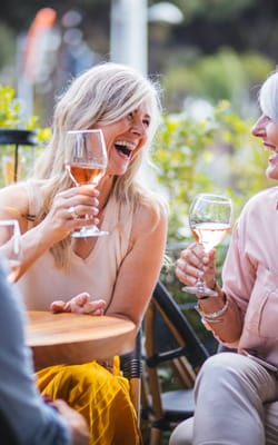 Two women enjoying drinks in an outdoor space
