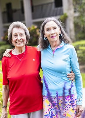 Two residents smiling in a garden