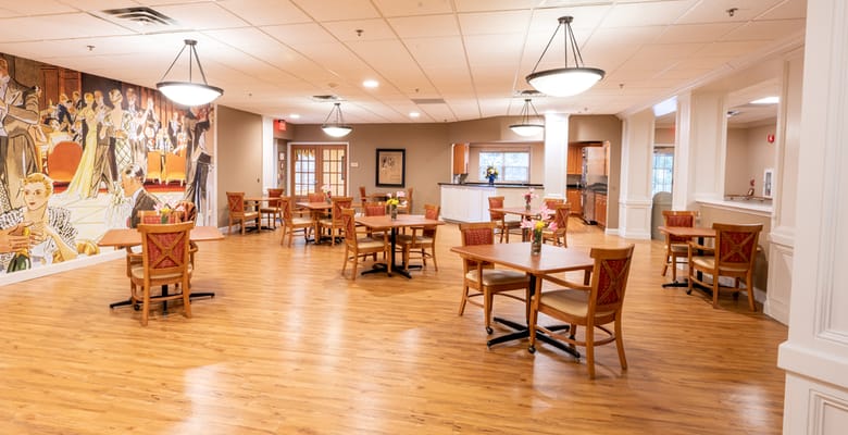Dining area with wooden tables and a mural