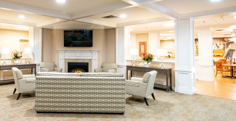 Bright common area with seating and fireplace