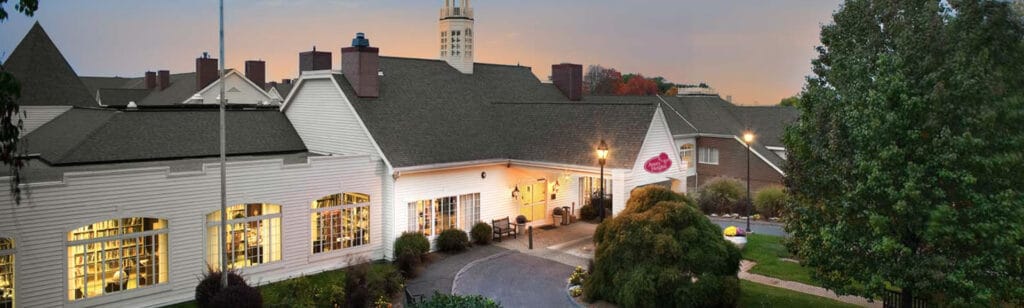 Exterior view of an assisted living facility with landscaped gardens