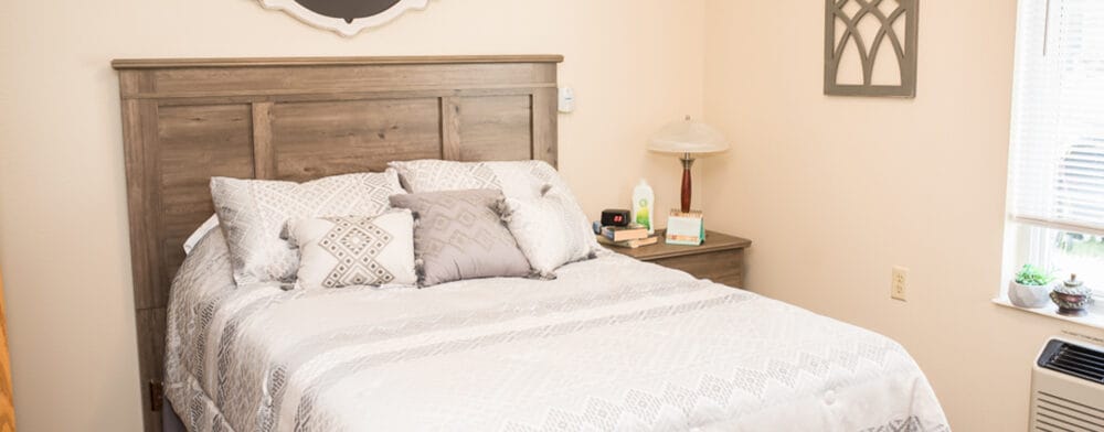 Bright, comfortable private resident room with a bed