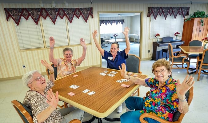 Residents enjoying a card game in a common area