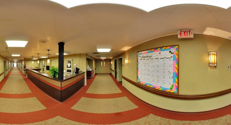 Interior hallway with bulletin board and exit sign