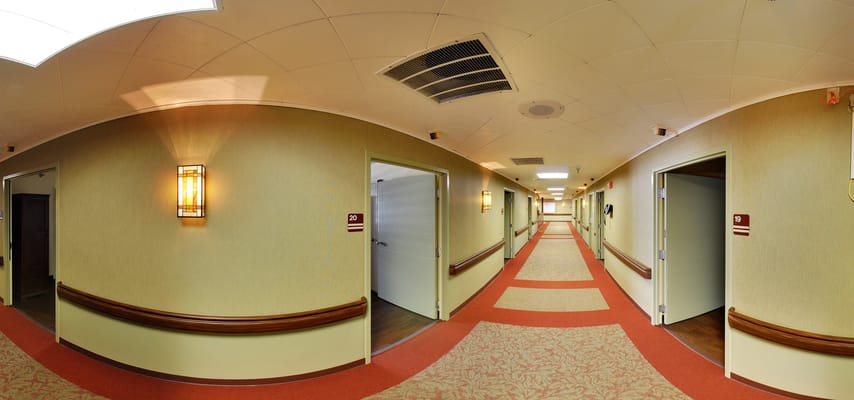 Interior corridor with resident rooms and lighting