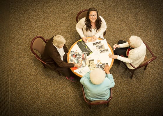 Residents engaged in an activity with staff member
