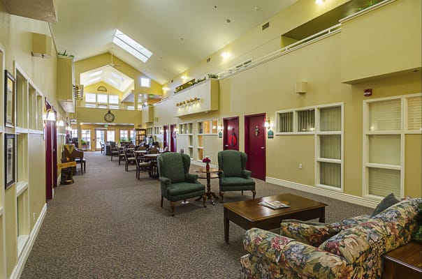 Bright common area with seating and decor in an assisted living facility