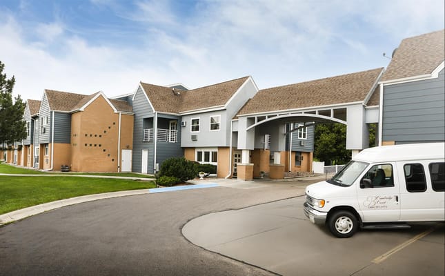Exterior view of assisted living facility with shuttle