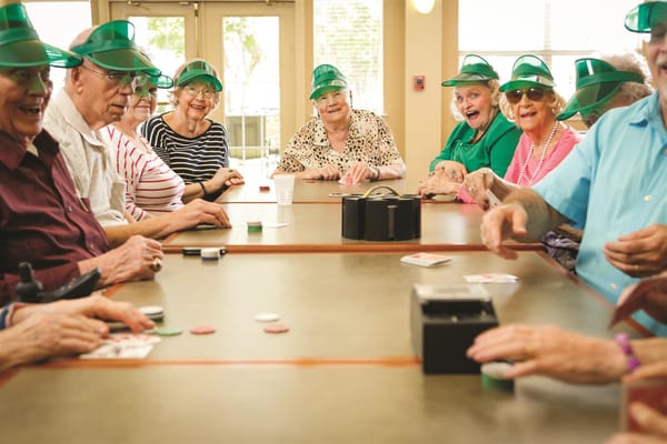 Residents playing a game at a community table