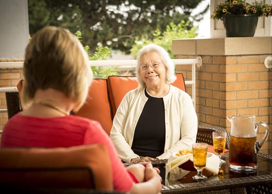 Resident enjoying a meal on a patio