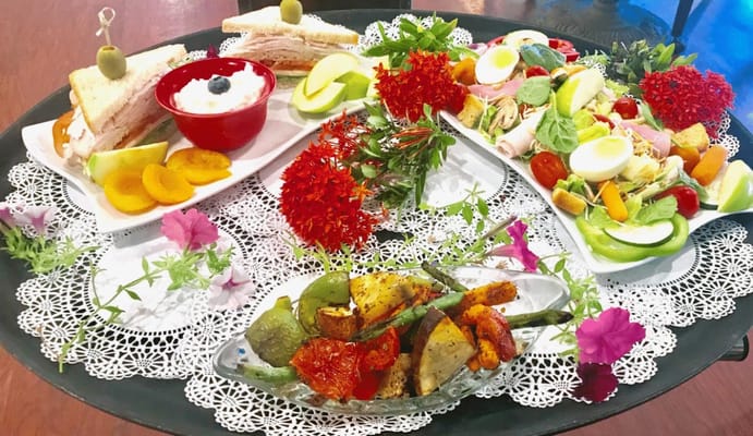 Platter of assorted sandwiches and salads with garnishes