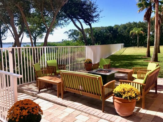 Outdoor seating area with potted flowers and trees