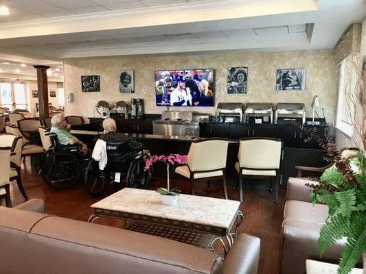 Residents enjoying a common area watching TV