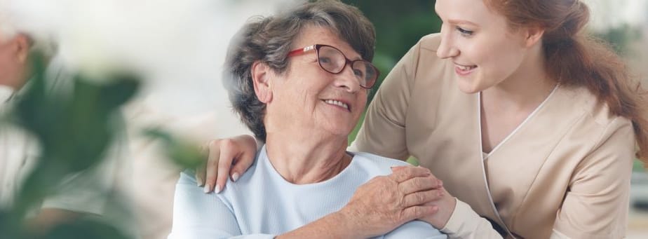 Staff member interacting with a resident in a warm setting