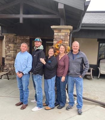 Staff members posing outside the facility entrance