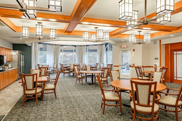 Brightly lit dining area with tables and chairs