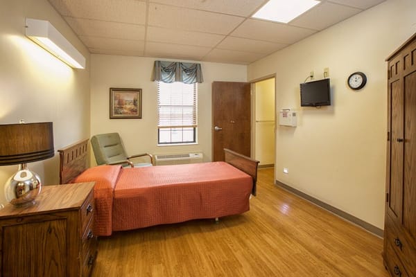 A private resident room with a bed and furniture