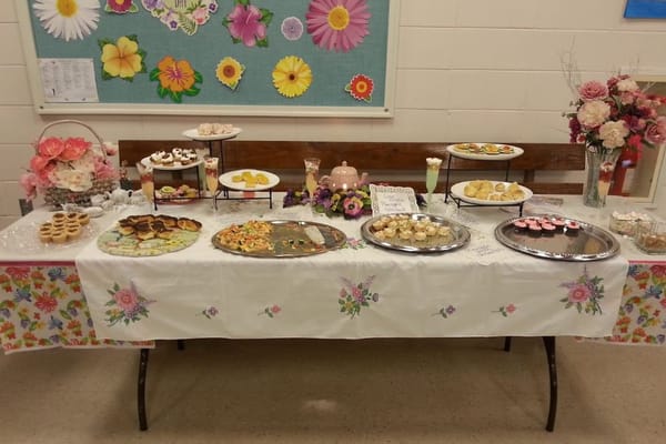 Table with various desserts and pastries for a community event
