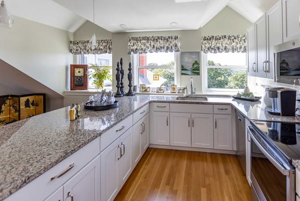 Modern kitchen with granite countertops and large windows