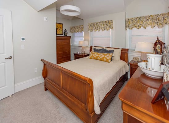 Spacious bedroom with a wooden bed and dresser