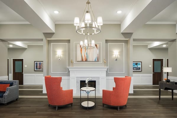 Cozy living room with orange chairs and decorative artwork
