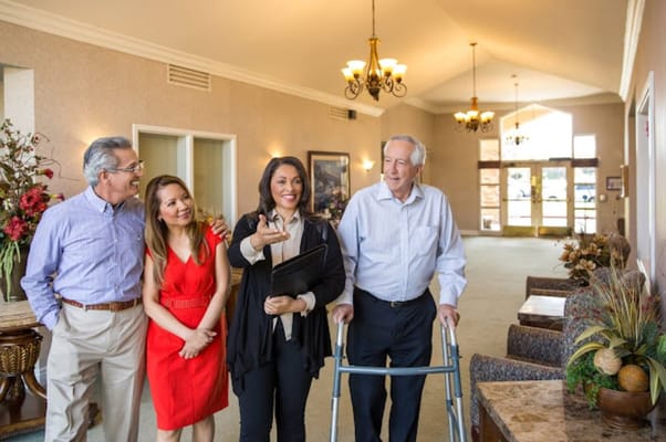 Residents and staff interacting in a bright lobby area