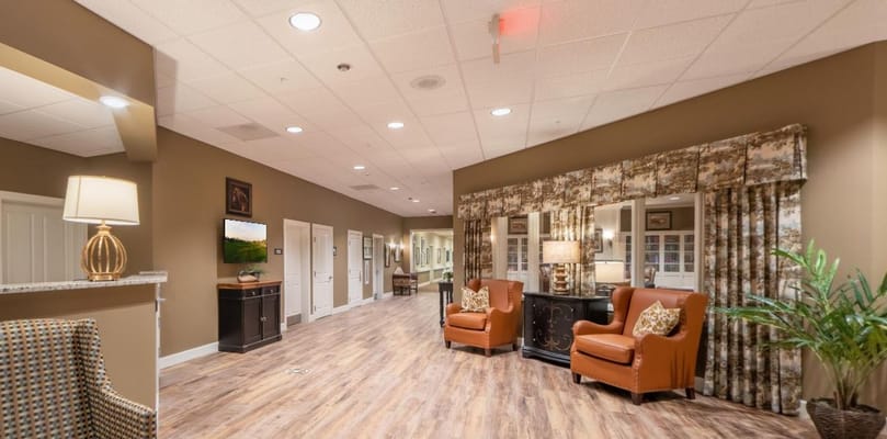 Cozy living room with brown walls and comfortable seating at Amber Creek Inn.