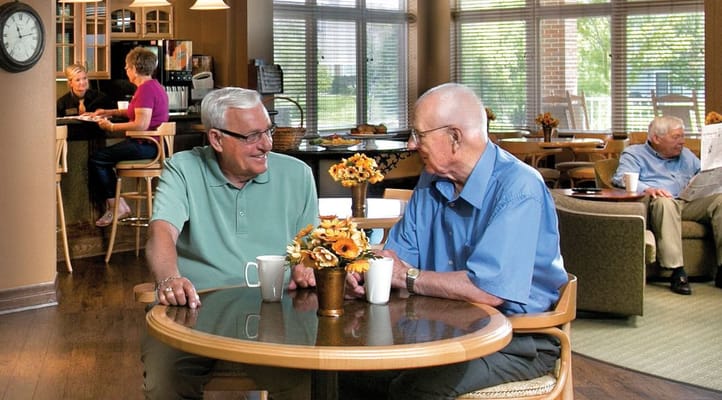 Two residents enjoying coffee in a common area