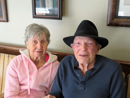 Elderly couple sitting together in a common area